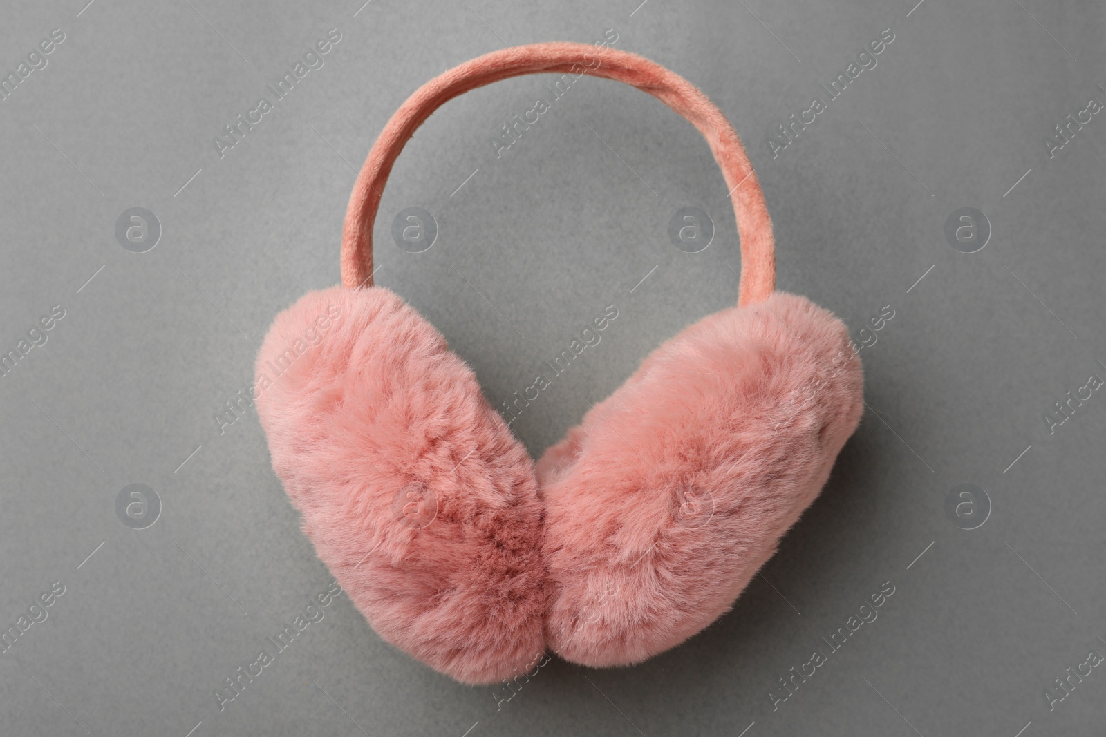 Photo of Stylish winter earmuffs on grey background, top view