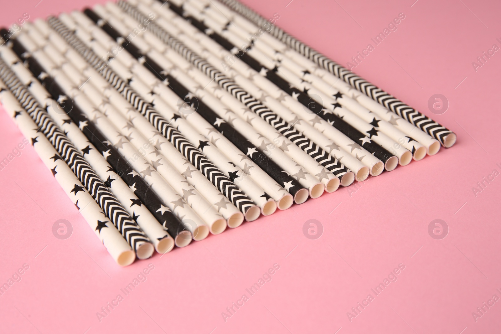 Photo of Many paper drinking straws on pink background