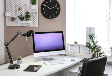 Stylish workplace with computer on table