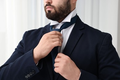 Photo of Businessman in suit and necktie indoors, closeup