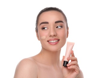 Photo of Woman holding tube of foundation on white background