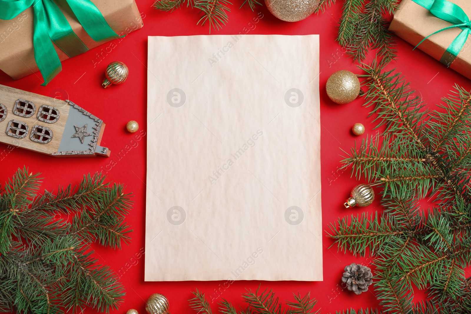 Photo of Blank paper with space for text and Christmas decor on red background, flat lay. Letter to Santa Claus