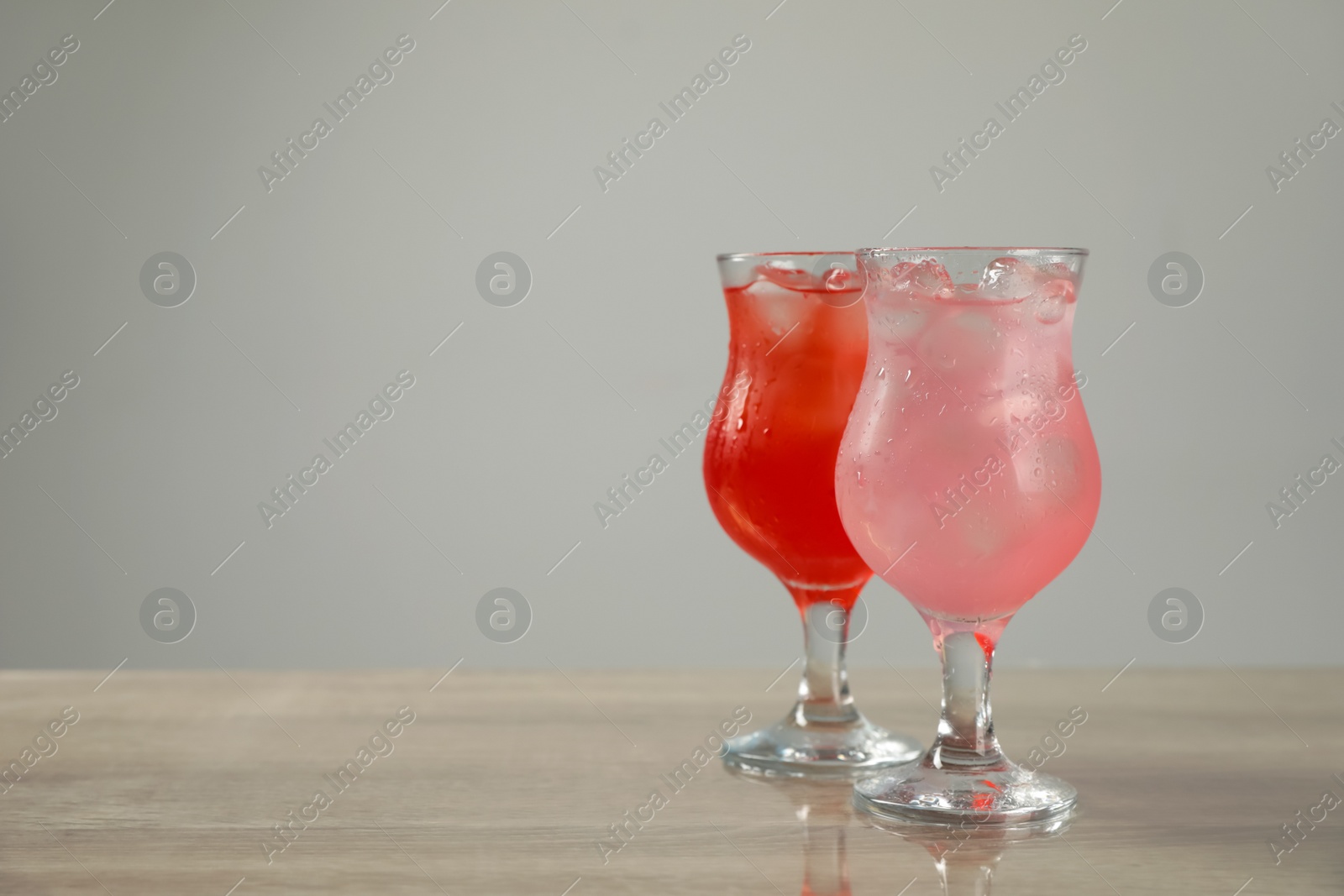 Photo of Delicious refreshing drinks on grey table. Space for text