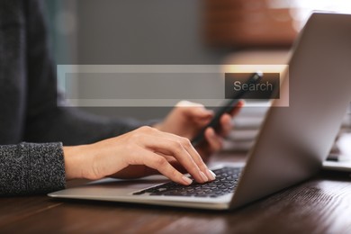 Search bar of website over laptop. Woman using computer at wooden table, closeup