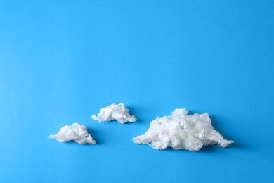 Photo of Clouds made of cotton on blue background. Space for text