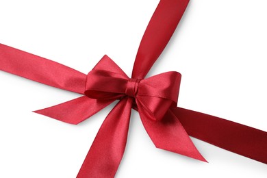 Red satin ribbon with bow on white background