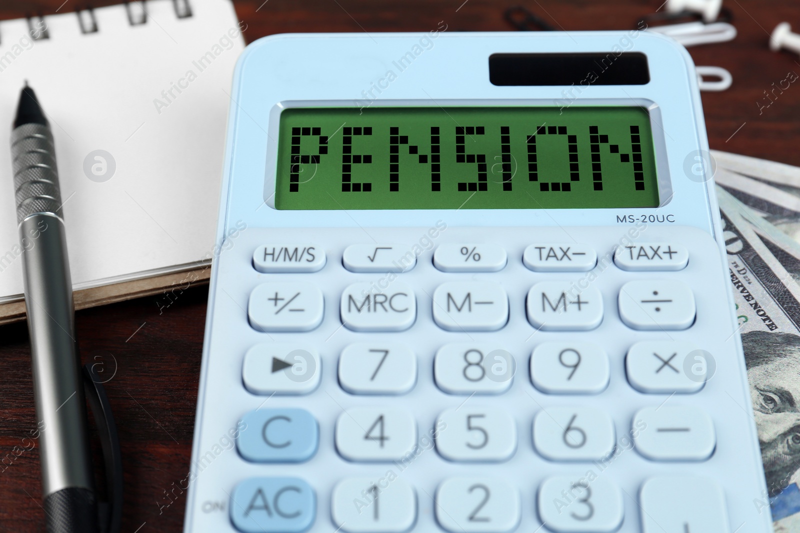 Image of Calculator with word Pension, money, pen and notebook on wooden table, closeup