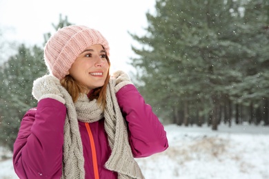 Photo of Portrait of beautiful woman in snowy forest. Space for text