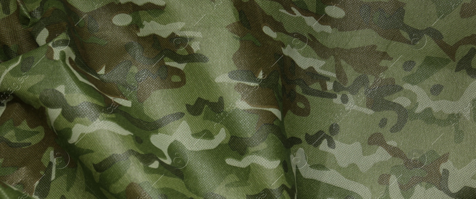 Photo of Texture of camouflage fabric as background, top view