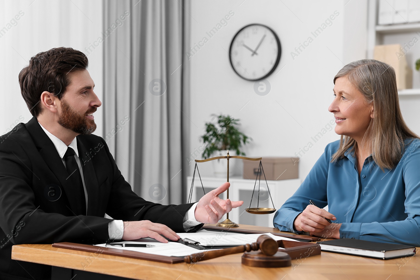 Photo of Senior woman having meeting with lawyer in office