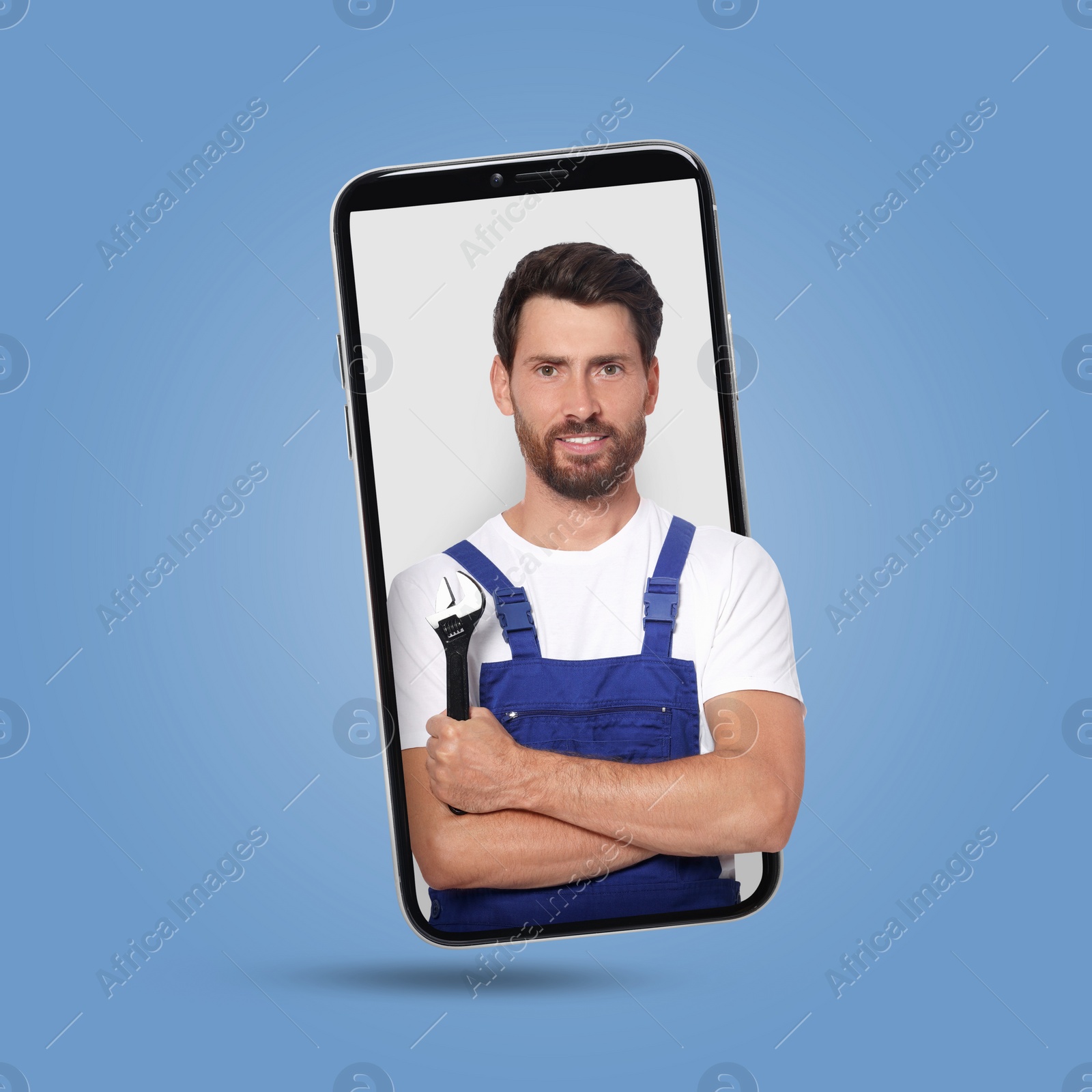 Image of Plumber looking out of smartphone on light blue background