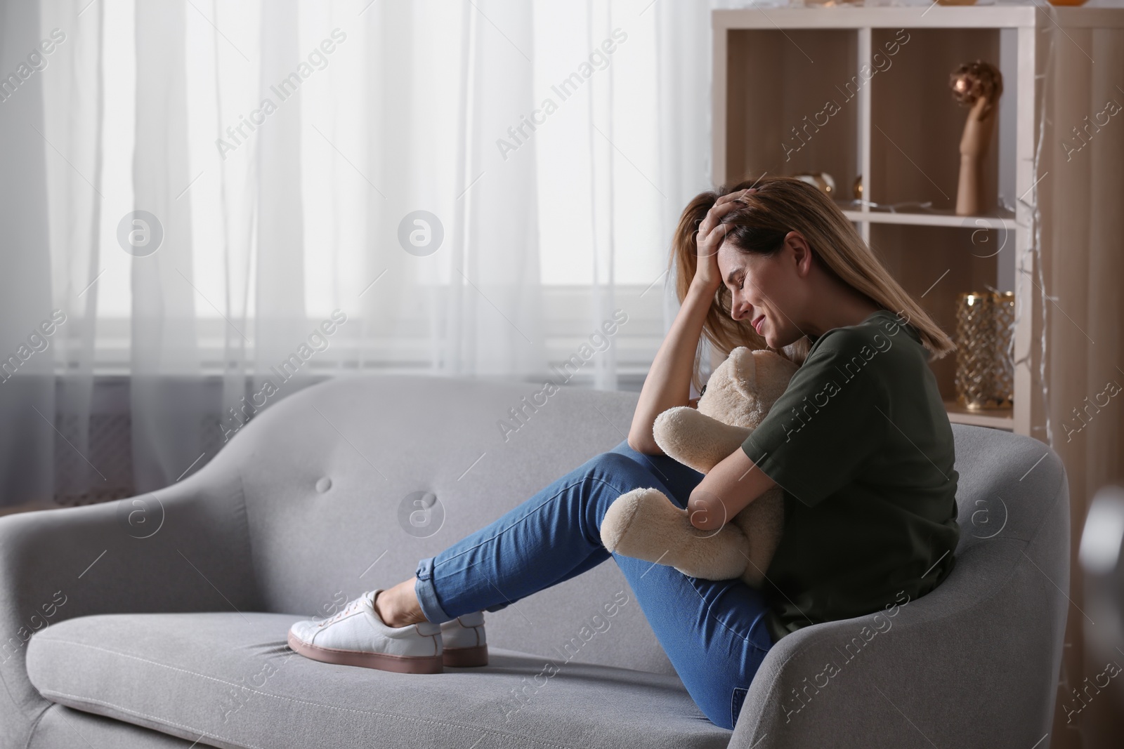Photo of Lonely woman suffering from depression at home