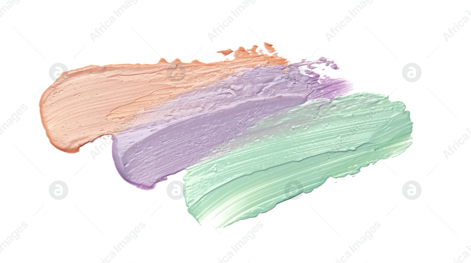 Photo of Strokes of pink, green and purple color correcting concealers isolated on white, top view