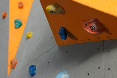 Photo of Climbing wall with holds, closeup. Extreme sport