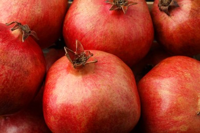 Photo of Many fresh ripe pomegranates as background, closeup