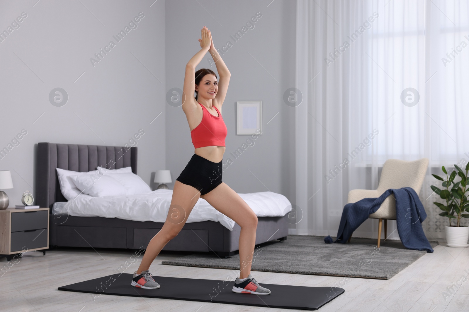 Photo of Happy woman doing morning exercise at home