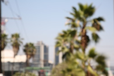 San Pedro Garza Garcia, Mexico – March 20, 2023: Blurred view of city with buildings and green palms