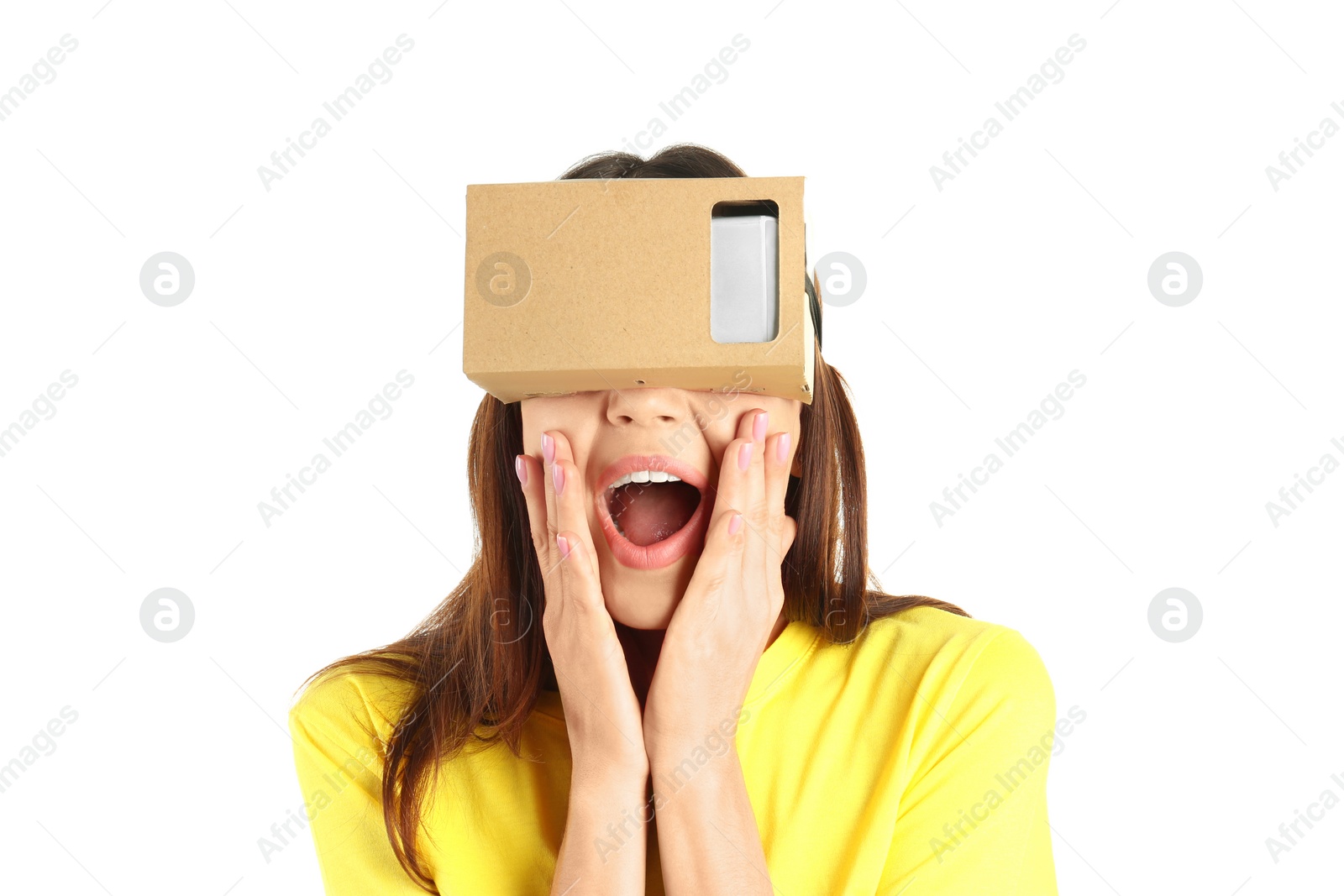 Photo of Young woman using cardboard virtual reality headset, isolated on white