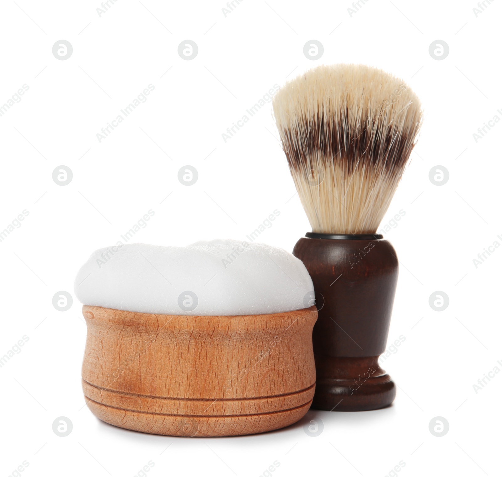 Photo of Shaving brush for men and bowl with foam on white background