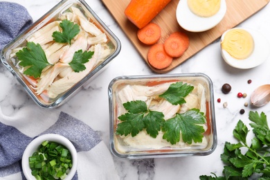 Delicious chicken aspic served on white marble table, flat lay