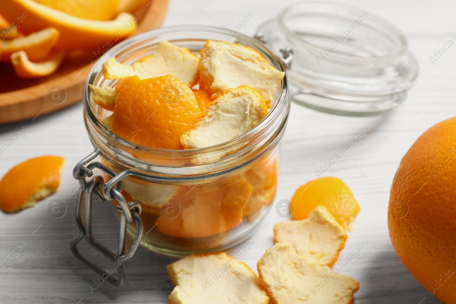 Photo of Orange peels preparing for drying on white wooden table, closeup