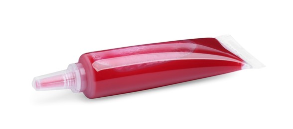 Photo of Tube with red food coloring on white background