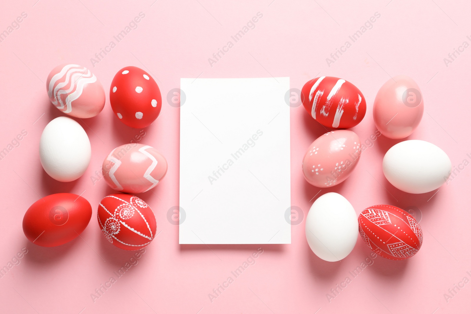 Photo of Flat lay composition of painted Easter eggs and card on color background, space for text