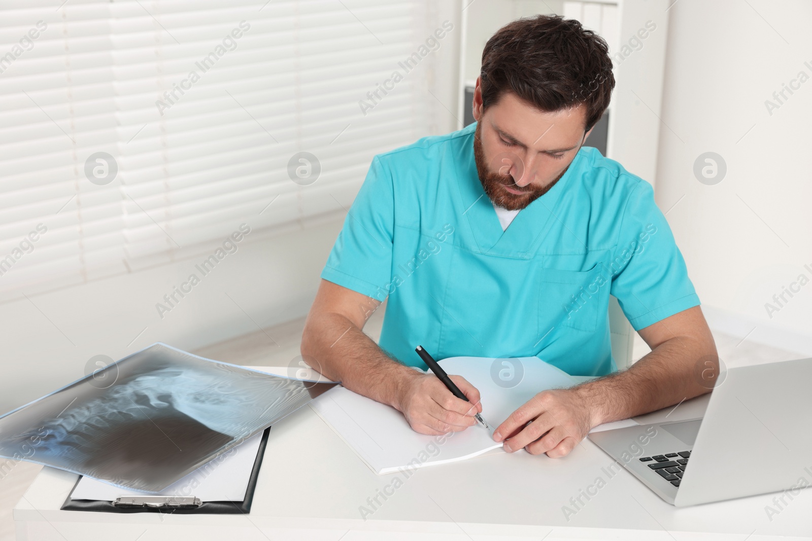 Photo of Doctor writing results from MRI scan in hospital