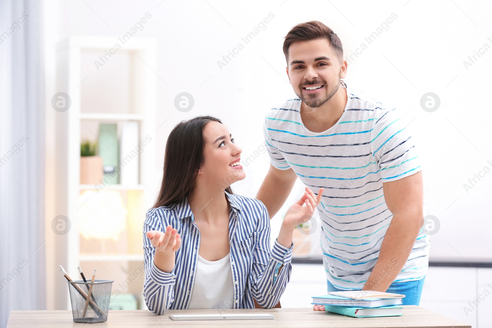 Photo of Happy couple using video chat for conversation indoors