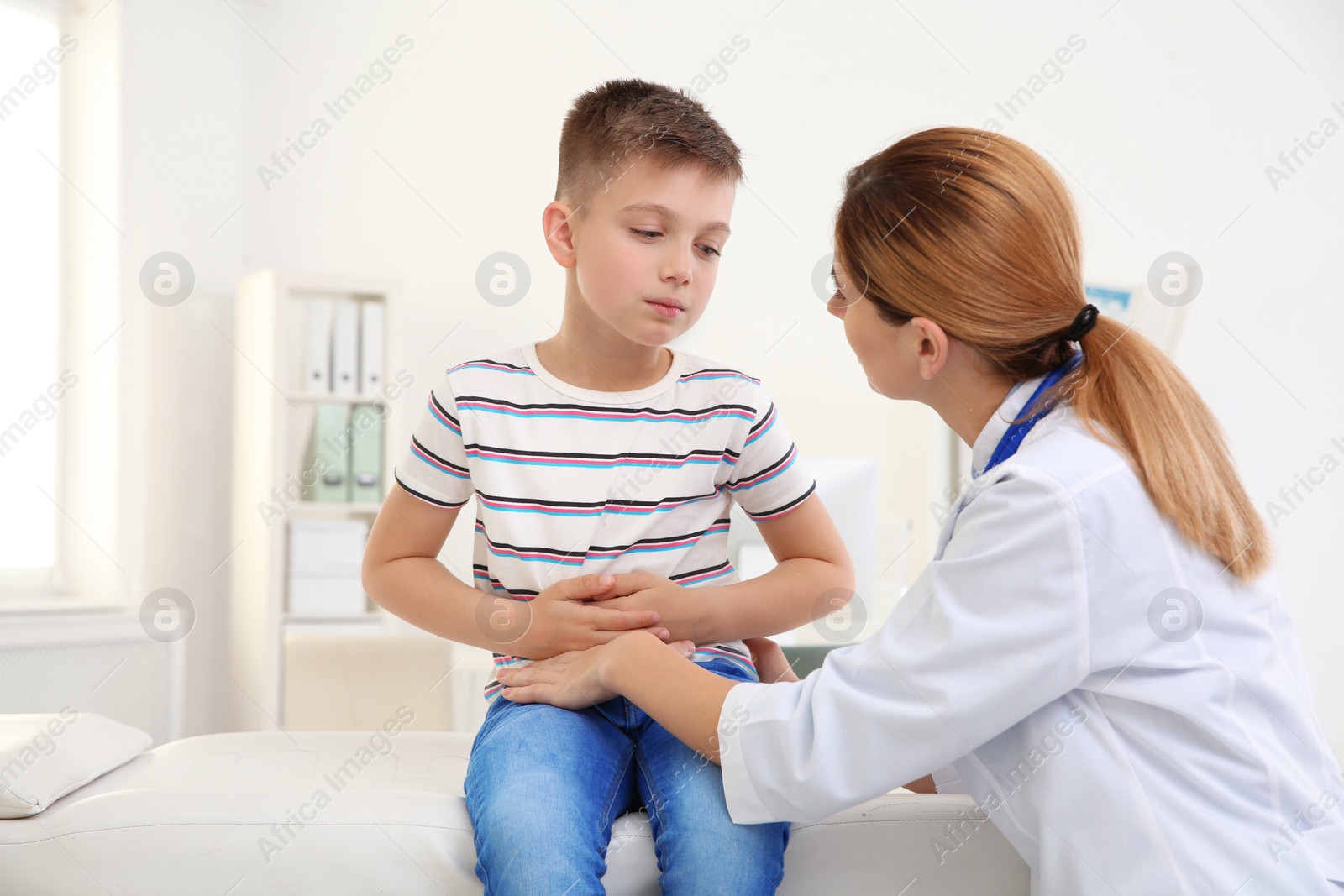 Photo of Doctor working with little patient in hospital