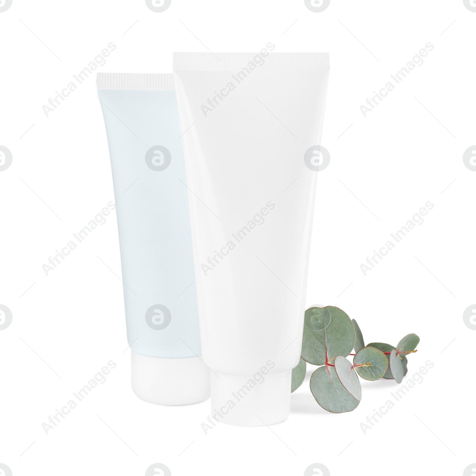 Photo of Tubes of hand cream and eucalyptus on white background