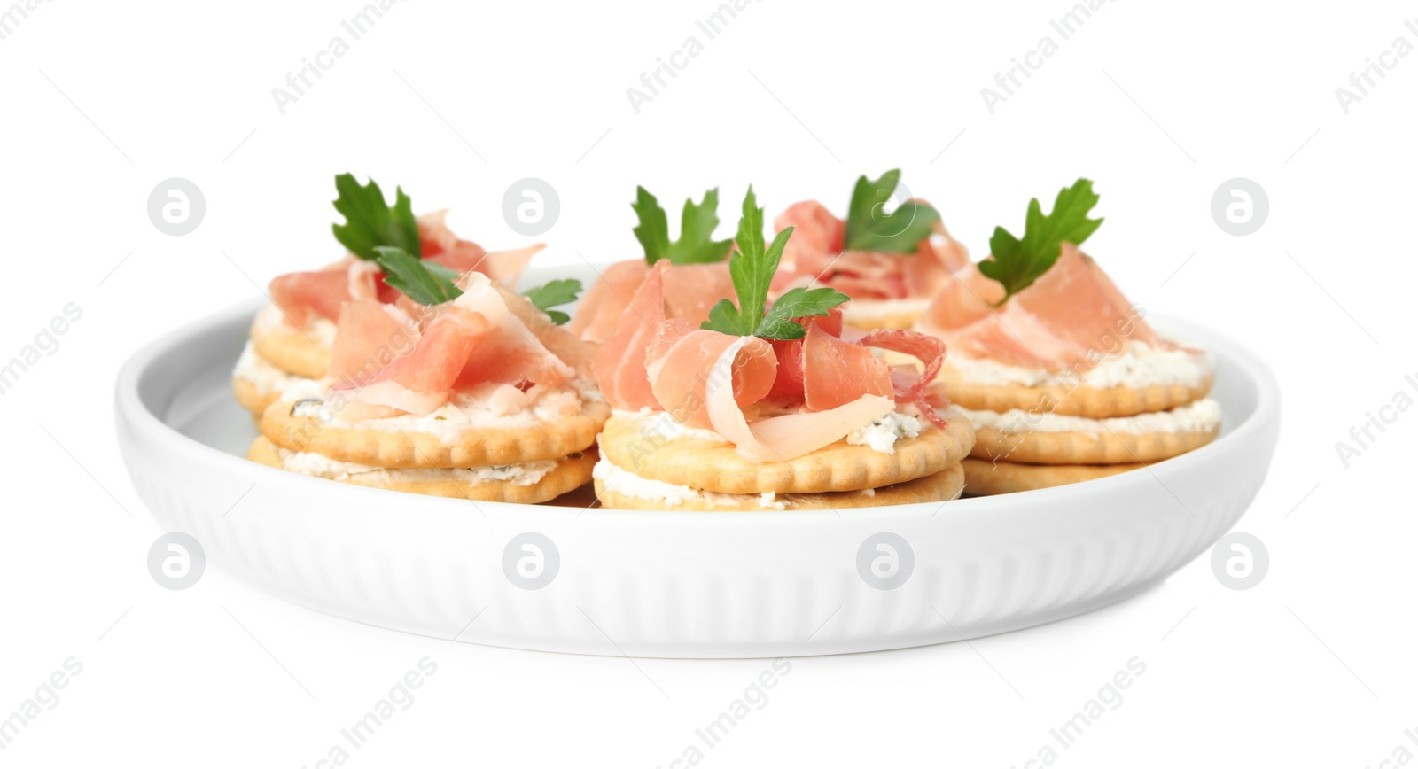 Photo of Delicious crackers with cream cheese, prosciutto and parsley on white background