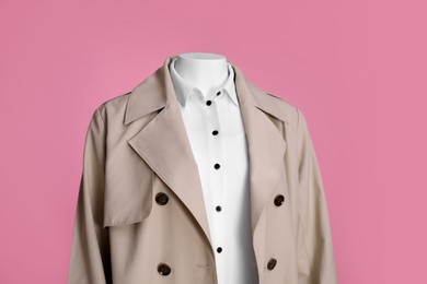 Photo of Female mannequin dressed in stylish stretch coat and shirt on pink background