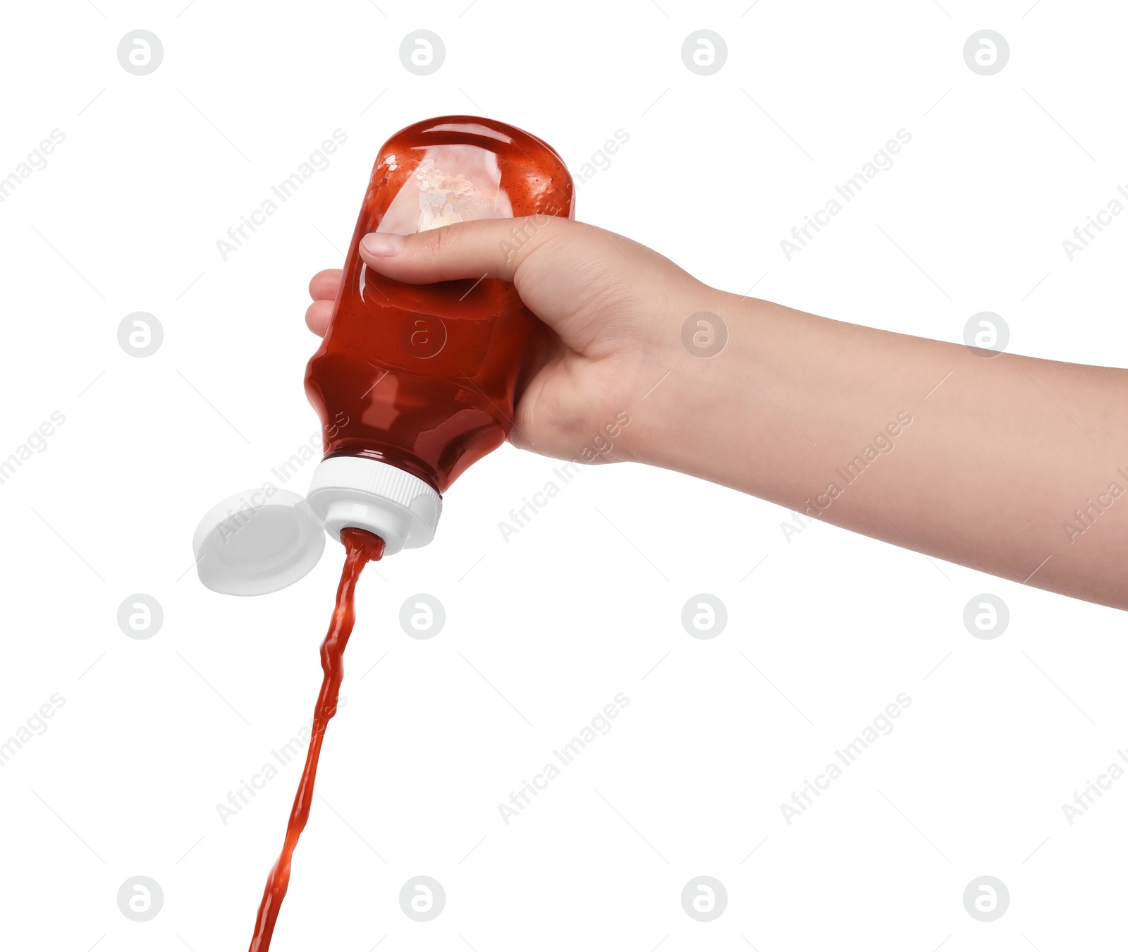 Photo of Woman pouring tasty ketchup from bottle isolated on white, closeup