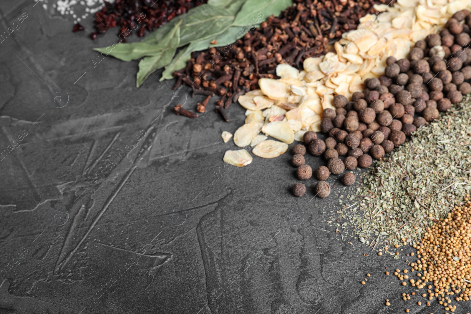 Photo of Many different spices on grey background. Space for text