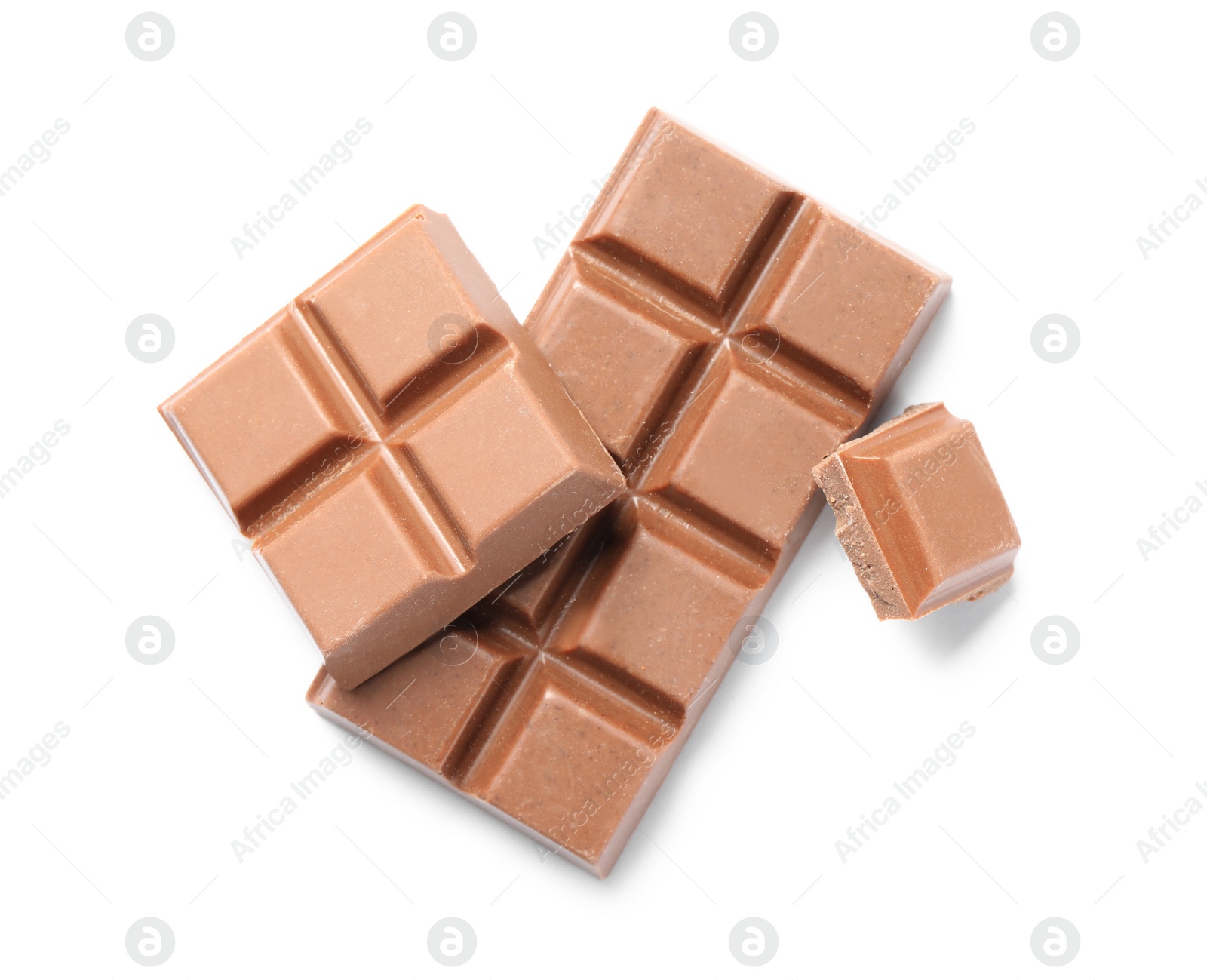 Photo of Pieces of delicious milk chocolate isolated on white, top view