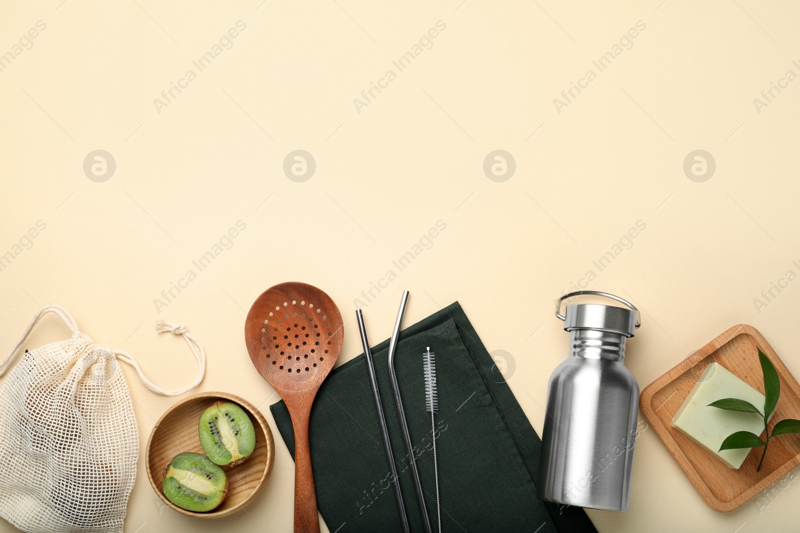 Photo of Flat lay composition with eco friendly products on beige background, space for text