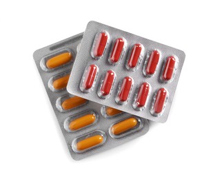 Blisters with different pills on white background, top view