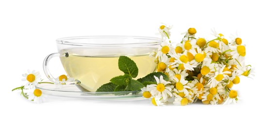 Photo of Aromatic herbal tea in glass cup with mint and chamomile flowers isolated on white