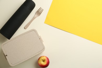 Thermos, lunch box and apple on color background, flat lay. Space for text