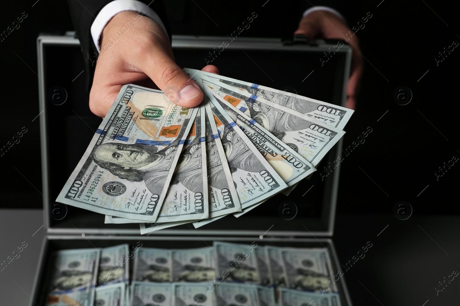 Photo of Businessman with suitcase offering money, closeup of hand