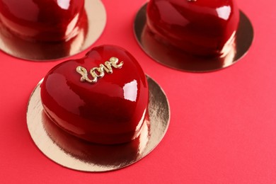 Photo of St. Valentine's Day. Delicious heart shaped cakes on red background, closeup