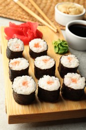 Photo of Tasty sushi rolls served on grey table