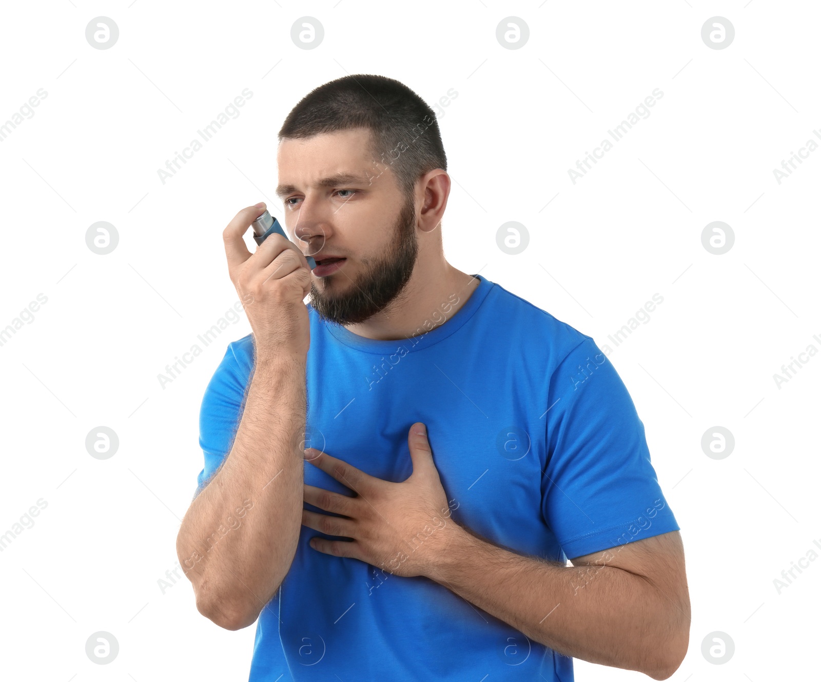 Photo of Young man using asthma inhaler on white background