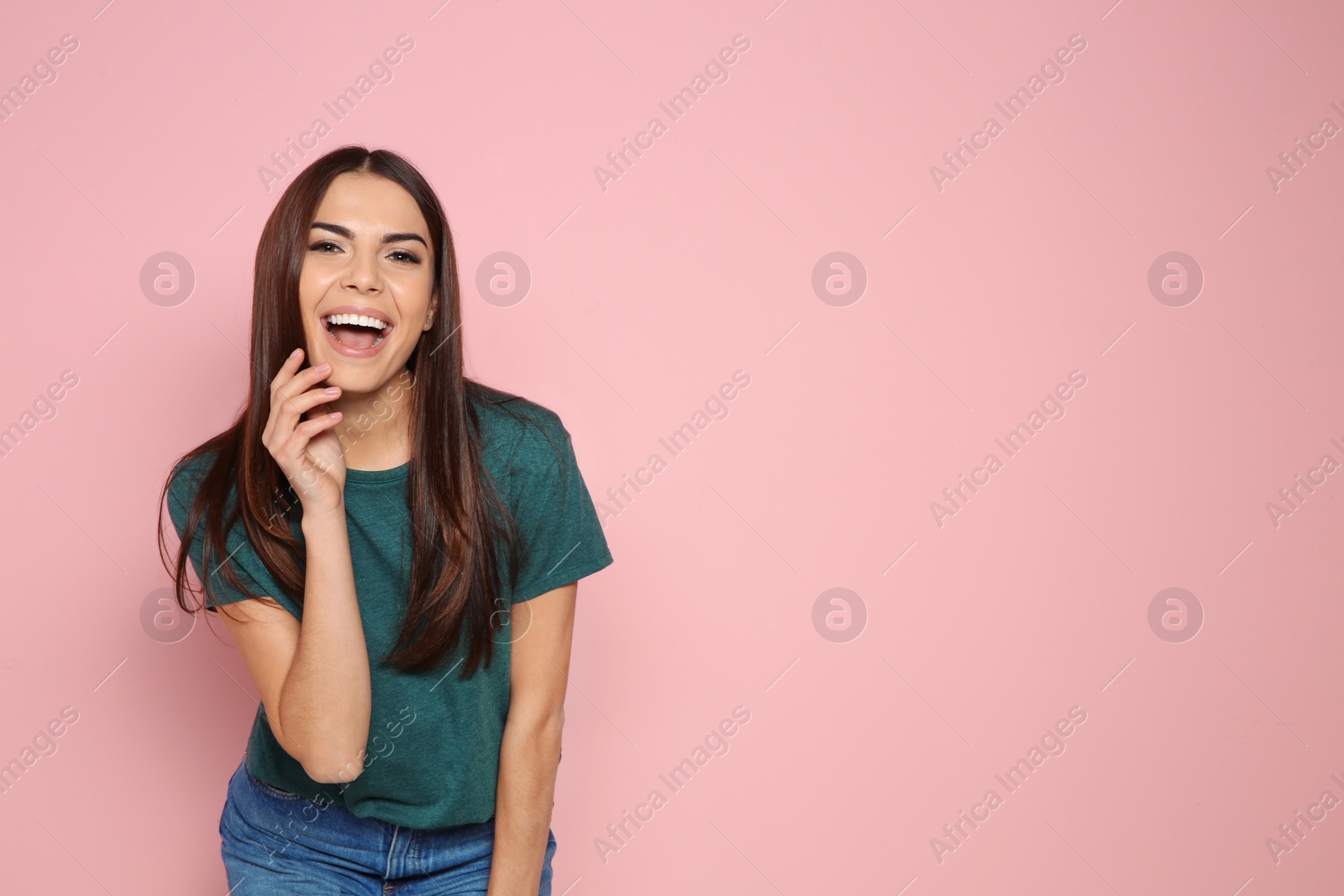 Photo of Portrait of young woman laughing on color background. Space for text