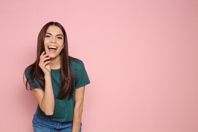 Photo of Portrait of young woman laughing on color background. Space for text