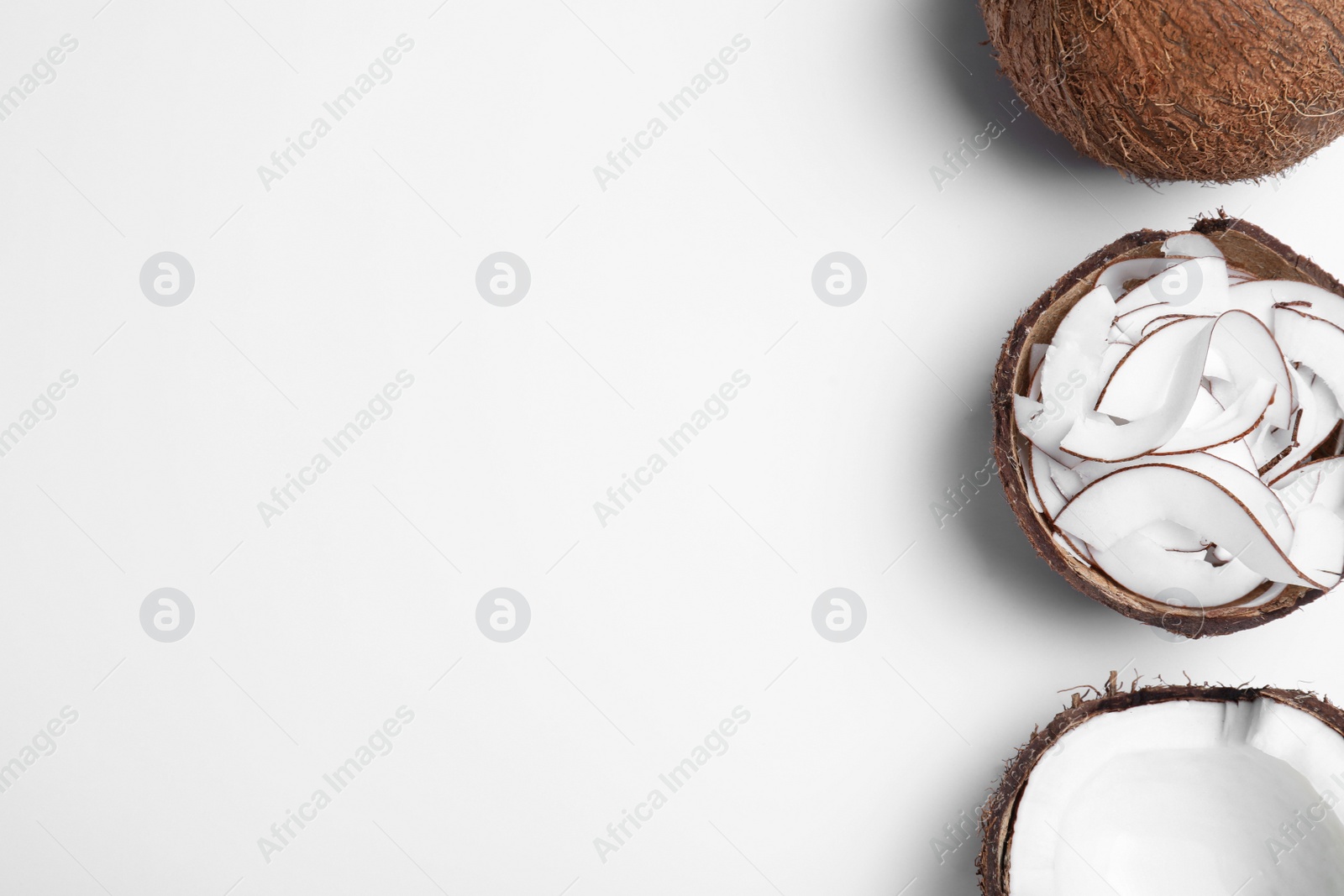 Photo of Composition with fresh coconut flakes on white background, top view