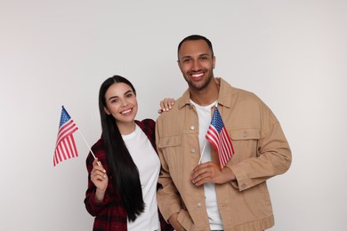 Photo of 4th of July - Independence Day of USA. Happy couple with American flags on white background