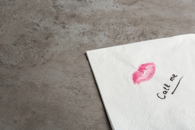 Photo of Paper napkin with lipstick mark, words CALL ME and space for text on grey background