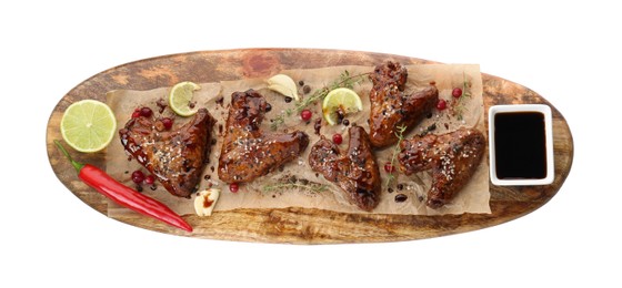 Photo of Tasty chicken wings glazed in soy sauce with garnish isolated on white, top view
